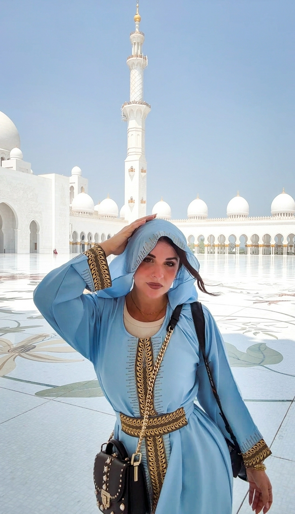 Sheikh Zayed Grand Mosque showcasing its magnificent domes and white marble architecture.