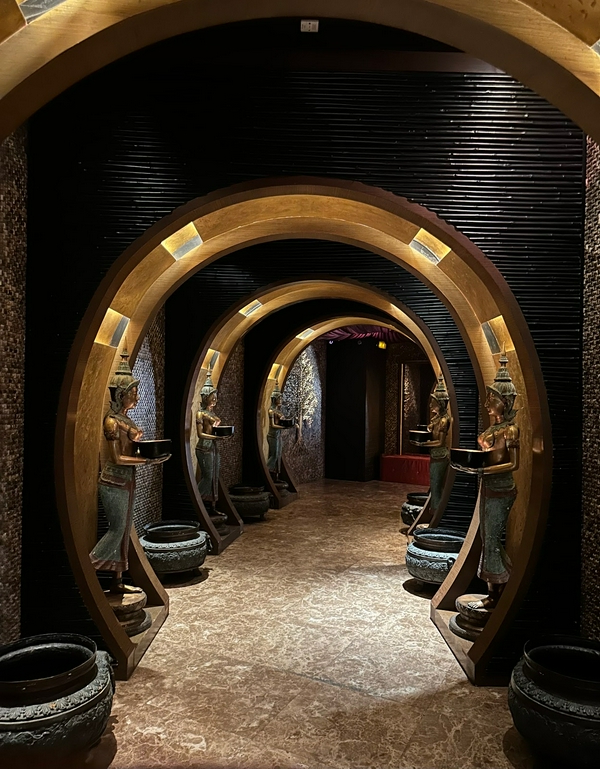 Impressive archway and prominent statue with elegant interior lighting.