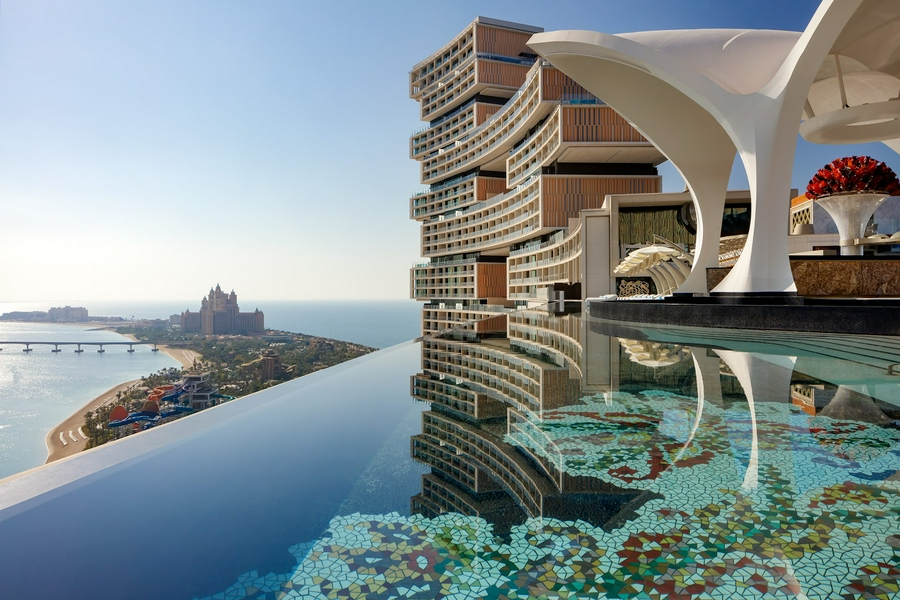 Modern building and serene water reflection at Cloud 22 Dubai.