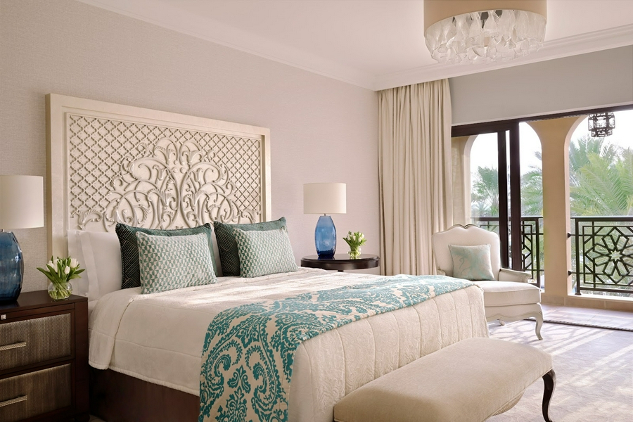 Luxurious bedroom interior at One&Only Royal Mirage with elegant furnishings and warm lighting.