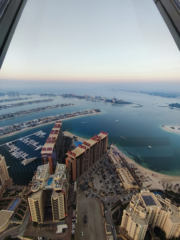 Aerial view of Palm Jumeirah highlighting its unique shape and surrounding waters.