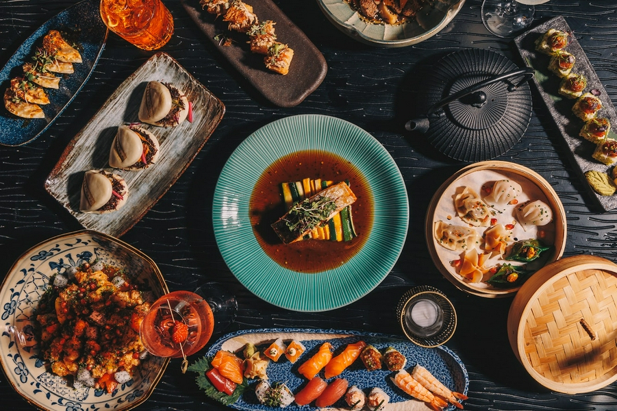 An assortment of Asian food including sushi and dumplings, highlighting gourmet culinary experiences.