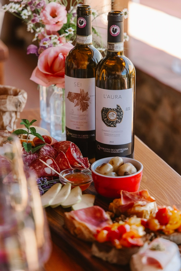 Wine bottles and charcuterie board featuring meats and cheese.