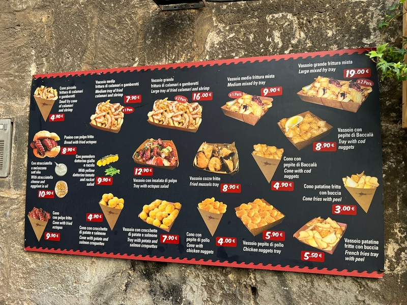 Street food vendors in Bari Vecchia showcasing local seafood and Italian cuisine.
