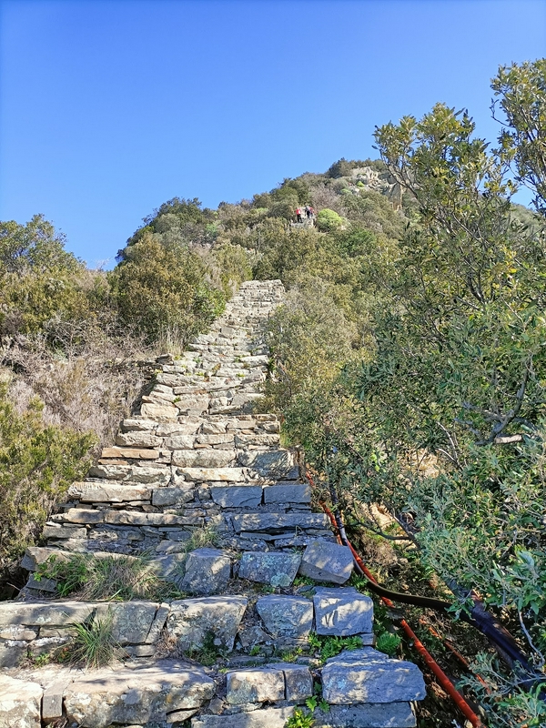 Family hiking the challenging staircase trail at Monesteroli