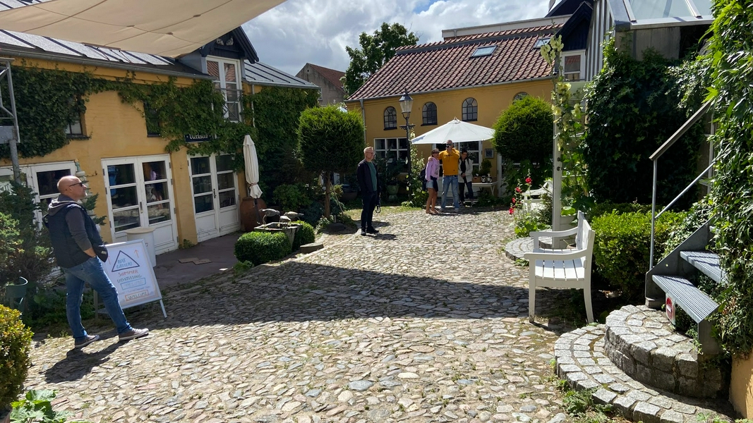 Hjelmerstald, a picturesque cobblestone street in Aalborg, Denmark.
