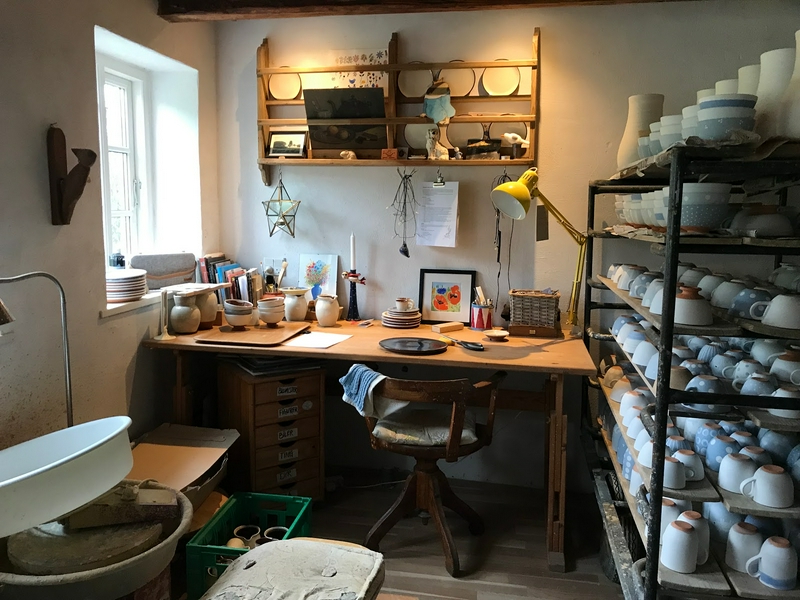 Cozy Danish cafe with a windmill and Rubjerg Knude Lighthouse nearby.