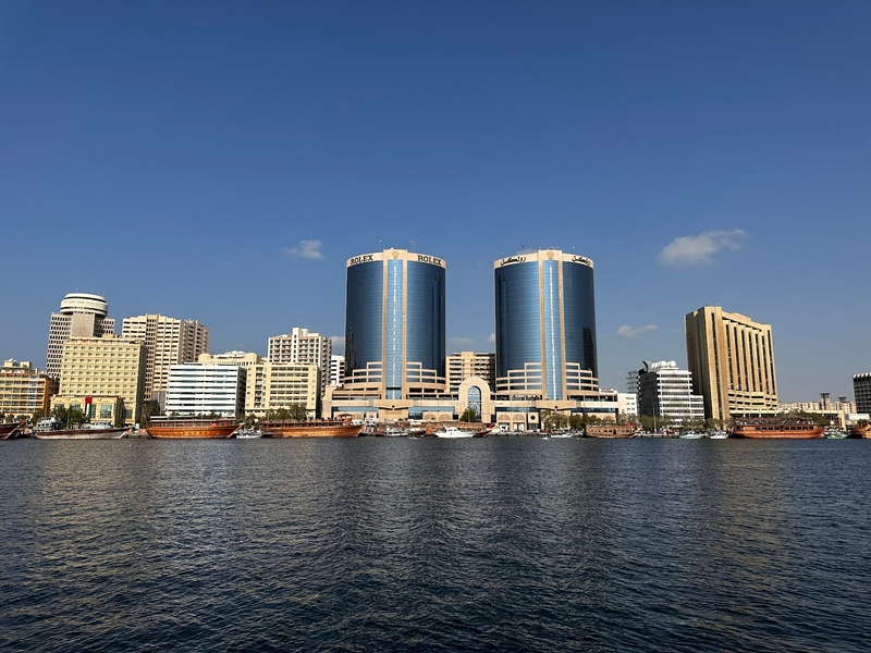 A scenic view of Dubai Old City showcasing unique buildings and water features.