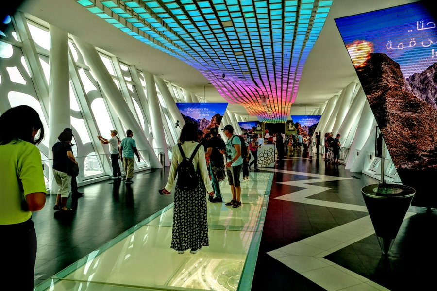 Visitors enjoying the architectural beauty of the Dubai Frame with a glass floor view.