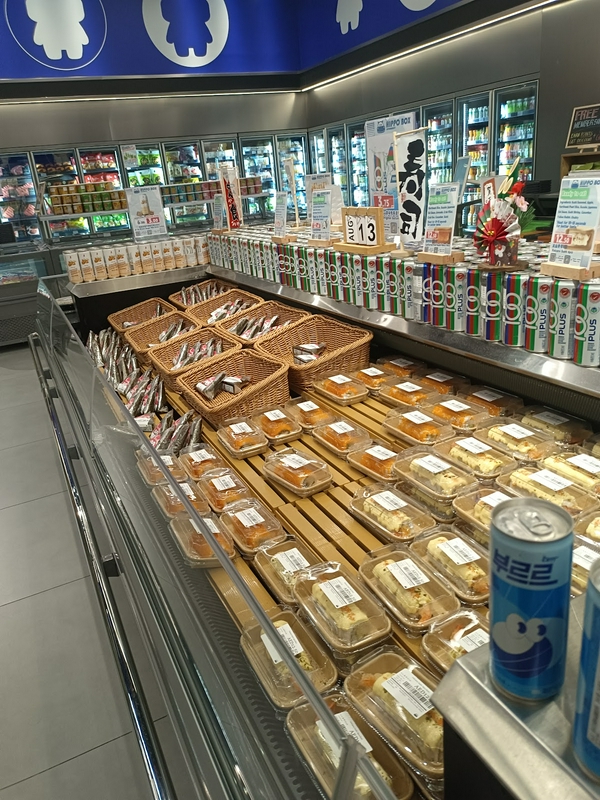 A vibrant supermarket showcasing diverse food and beverage options on organized shelves.