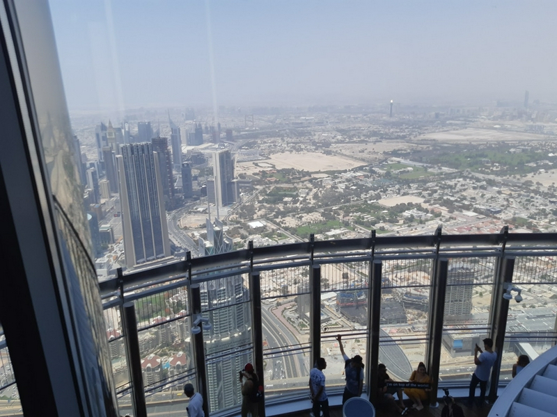 Panoramic view of Dubai's cityscape from Burj Khalifa's observation deck.