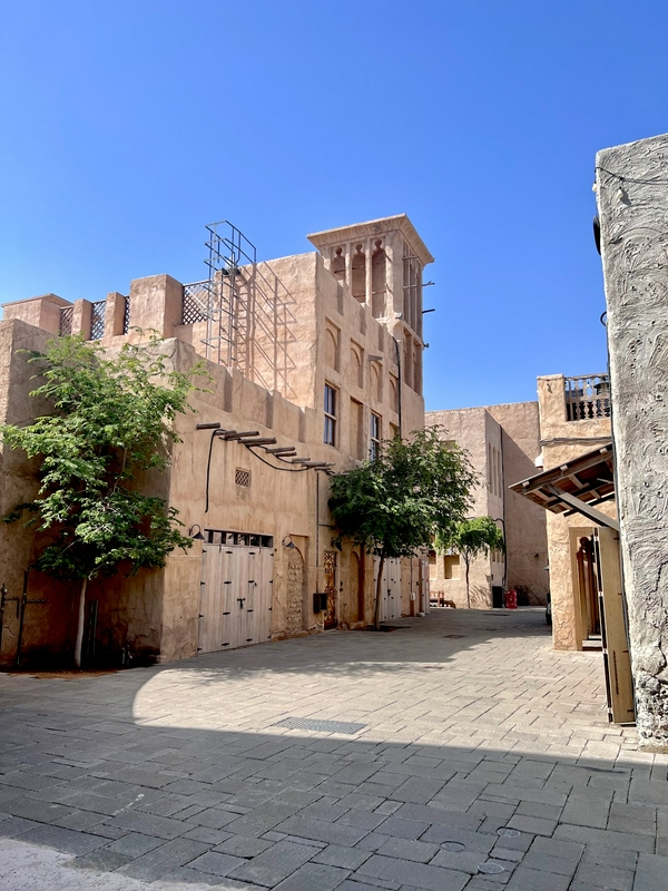 Visitors exploring the historical architecture of Dubai's old city.
