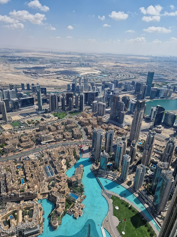 Aerial view of a vibrant cityscape showcasing skyscrapers and water features.
