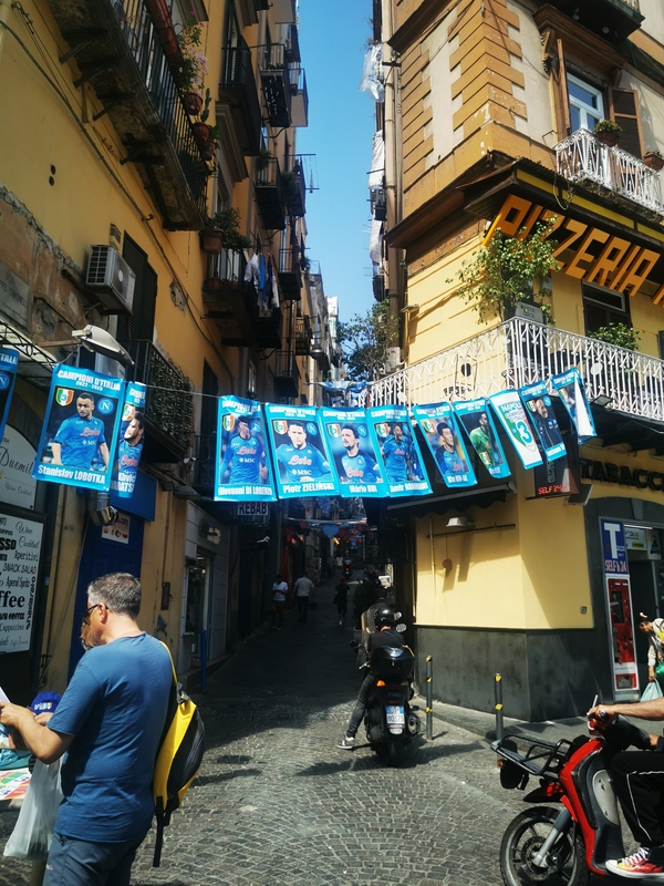 Via Toledo, a lively shopping street in Naples, Italy, showcasing vibrant urban architecture.