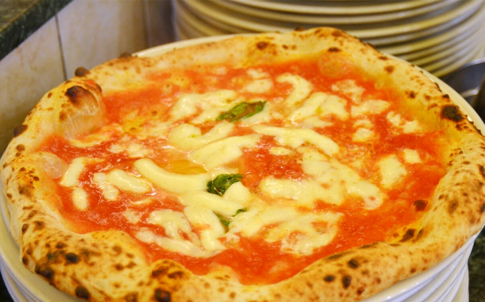 Delicious pizza served at Pizzeria Da Attilio in Naples, Italy.