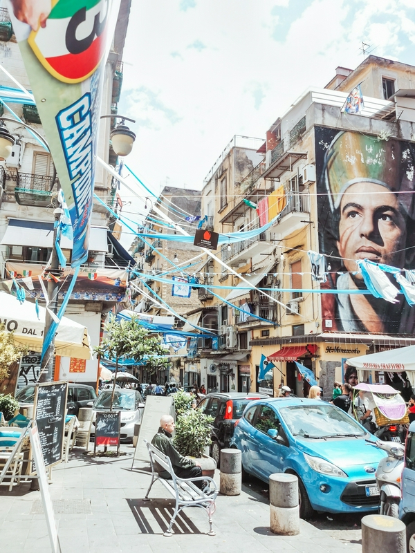 Families exploring the historic streets of Naples.