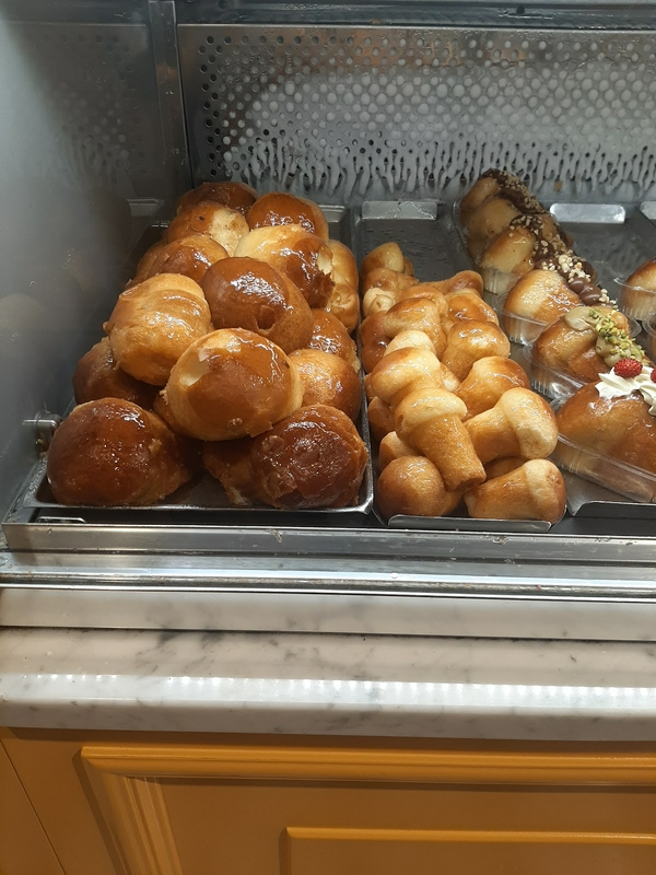 Traditional Italian sfogliatelle pastries with pistachio filling and savory options.