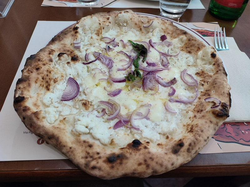 Delicious pizza served at Pizzeria Da Attilio, a top Italian dining destination.