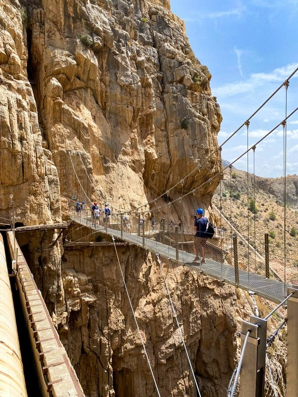 Hikers on the thrilling Caminito del Rey suspension walkway in Andalusia.