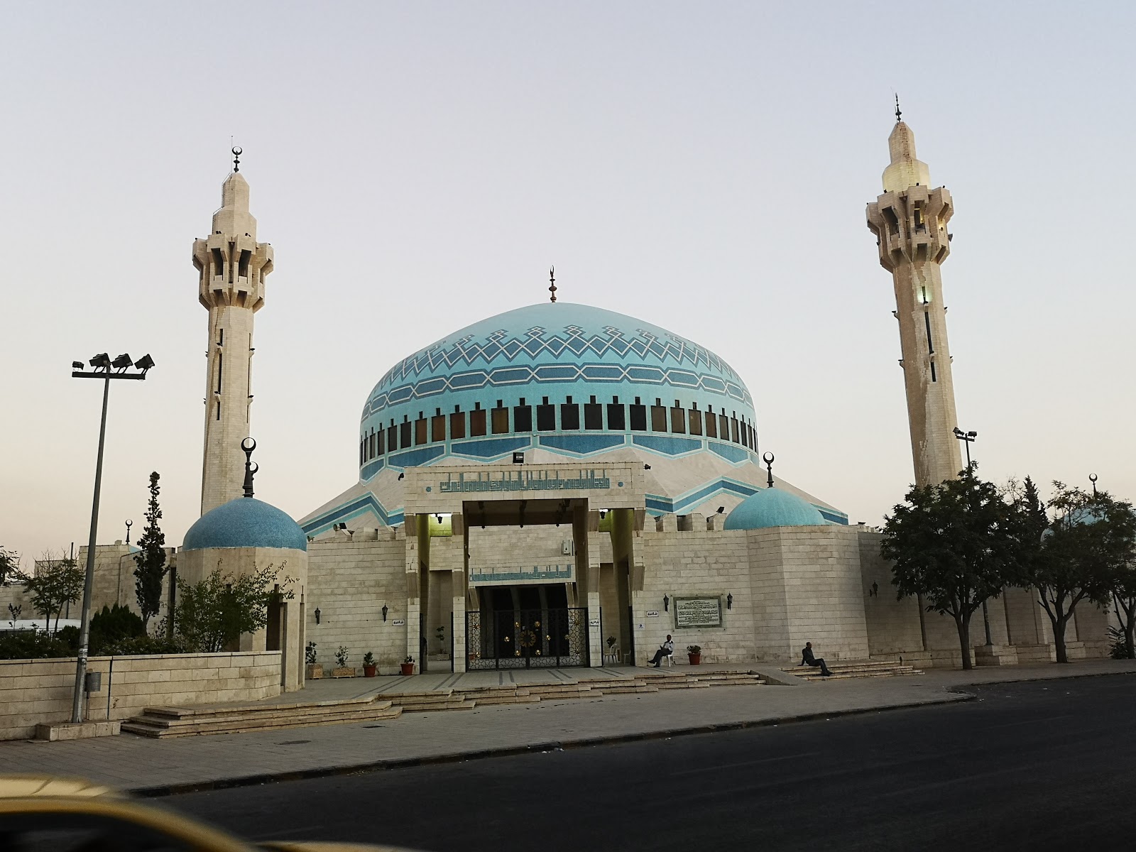 Visitors exploring the stunning architecture of King Abdullah I Mosque in Amman, Jordan.