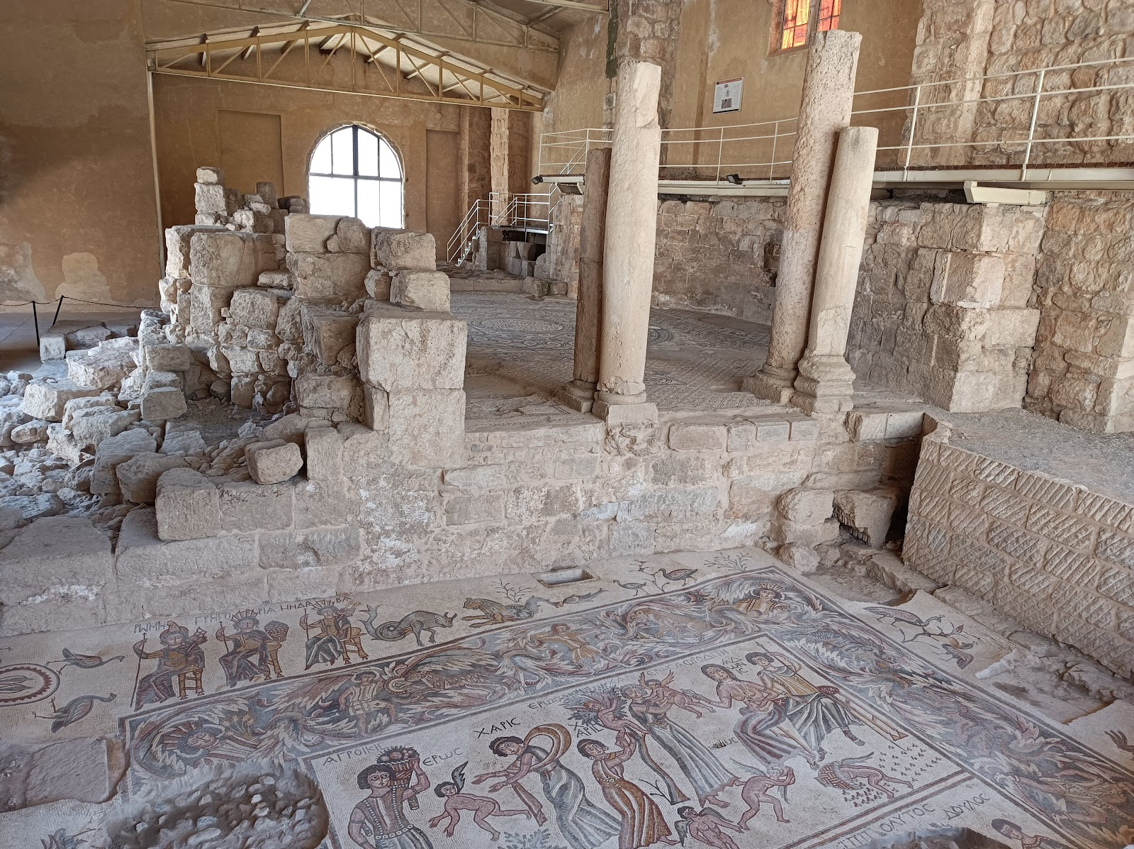 Visitors exploring the outdoor archaeological sites of Madaba.