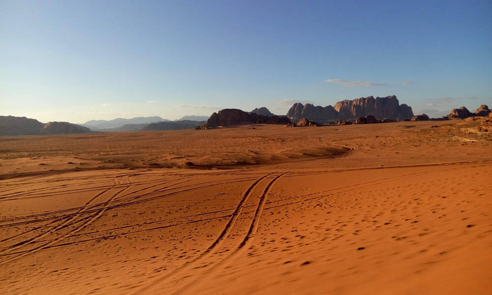 Stunning view of Wadi Rum desert with mountains and clear sky.