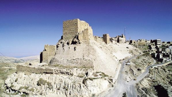 Visitors exploring the outdoor grounds of AlKarak Castle with stunning views.