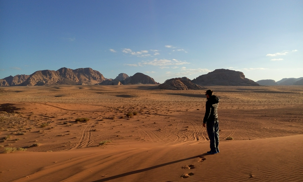 Breathtaking landscape of Wadi Rum featuring deserts, mountains, and a vibrant sky.