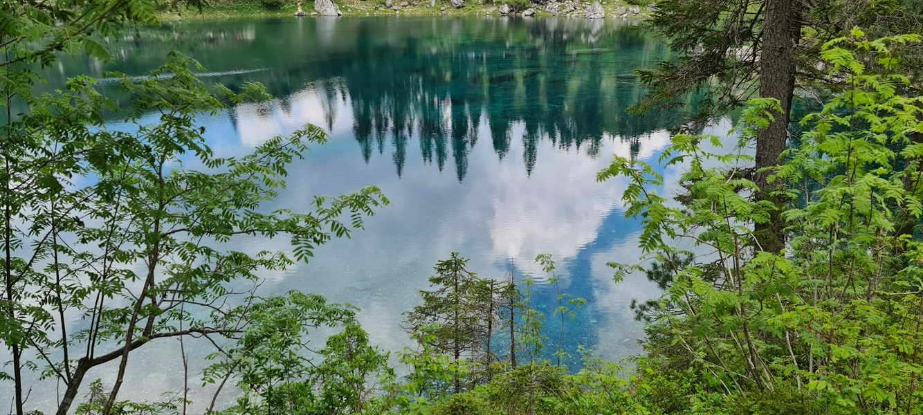 Lago di Carezza, a picturesque alpine lake with emerald waters in the Dolomites, Italy.