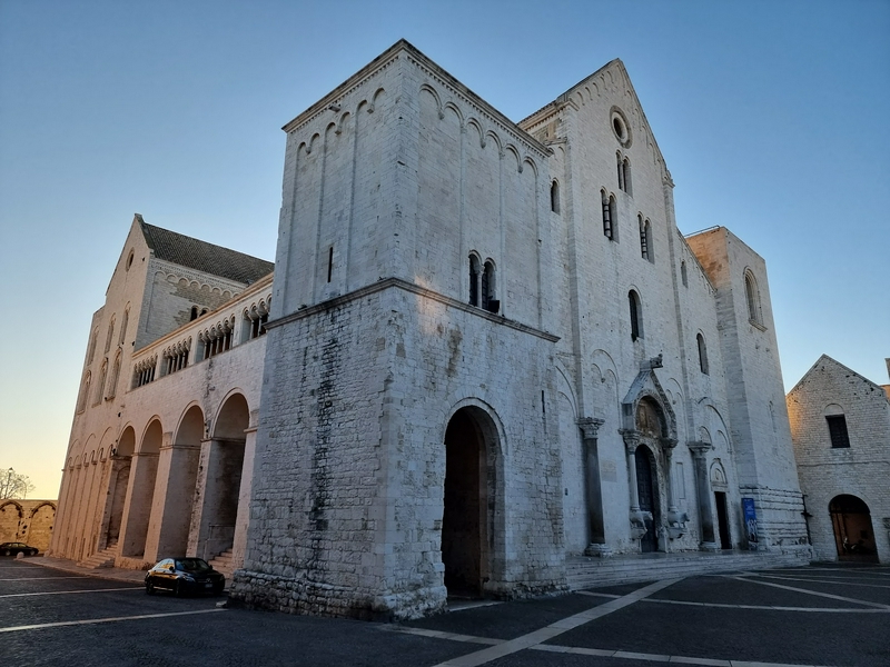 Visitors exploring the basilica's intricate architecture in a vibrant urban environment.