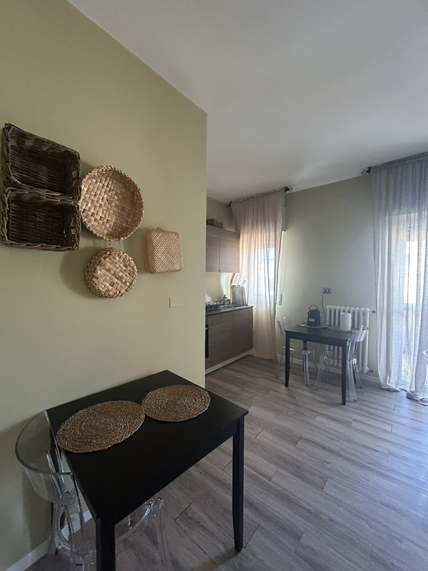 Interior view of a stylish accommodation with a modern kitchen and cozy dining area.