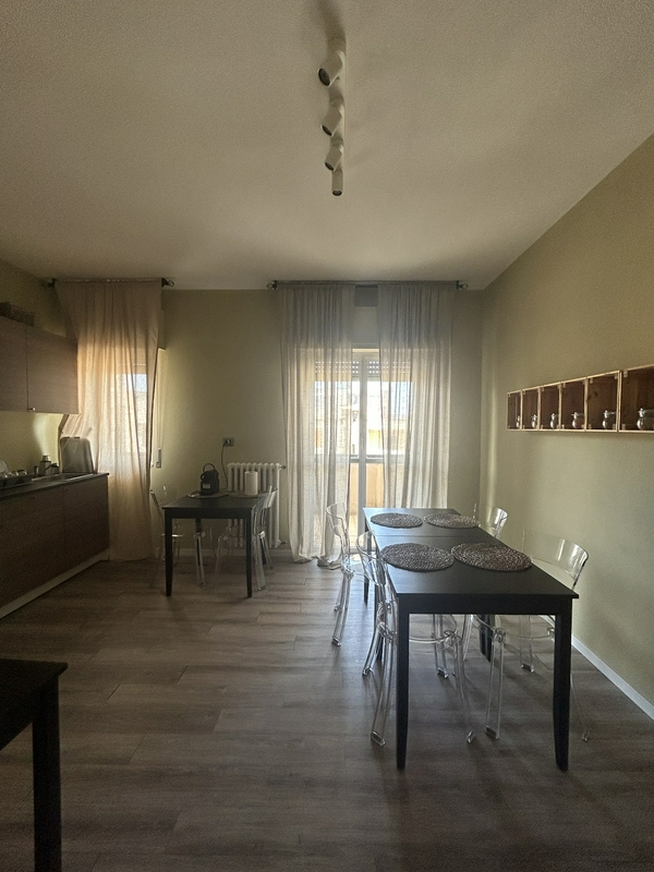 Stylish dining room with a wooden floor, elegant table, and chairs.