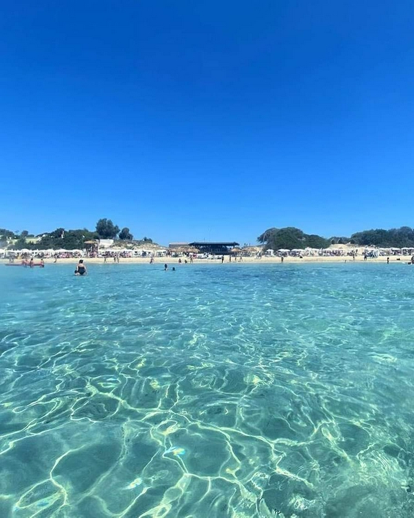 Torre Lapillo Beach featuring clear water and golden sand