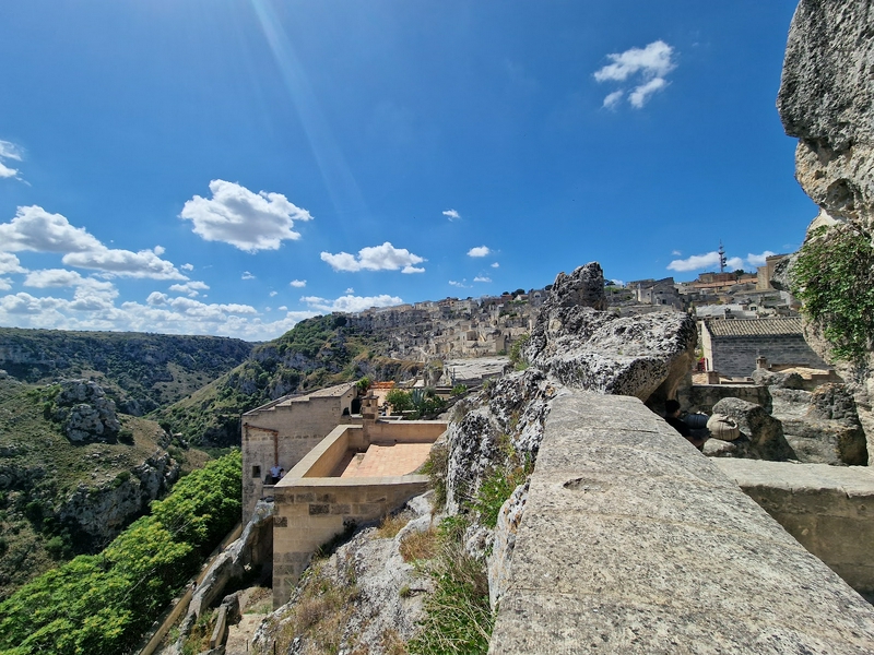 Expansive sky with clouds over the landscape of Casa Grotta nei Sassi di Matera.