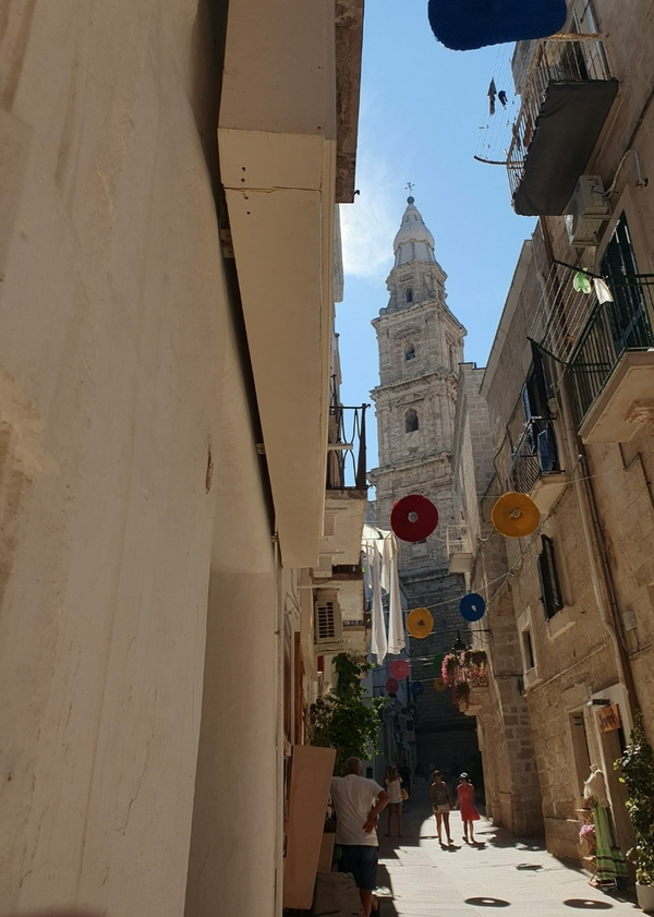Charming narrow streets and historical architecture of Monopoli bathed in sunlight.