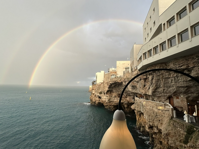 Intimate outdoor dining experience at Grotta Palazzese in a cave.