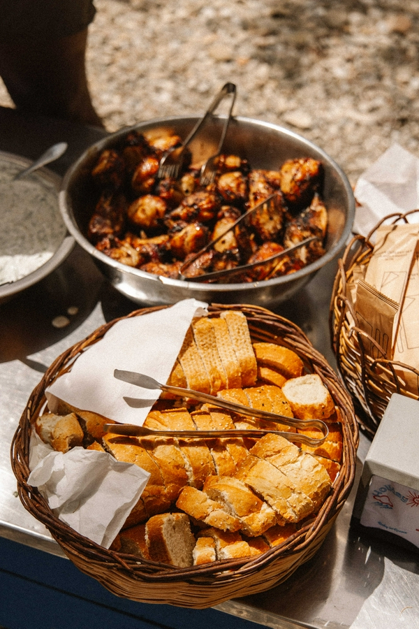 Delicious meal with grilled chicken and bread during Poseidon boat tour.