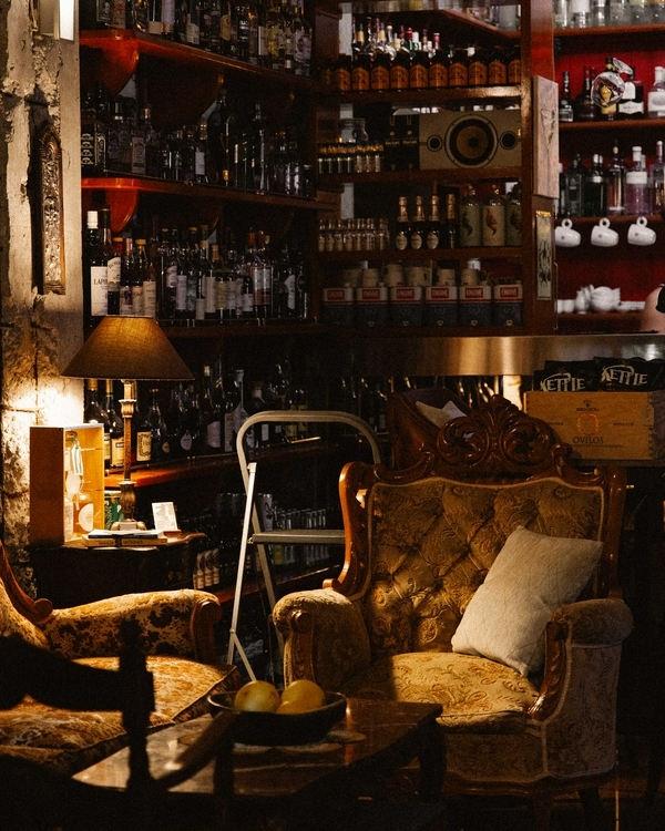 Cozy interior with stylish furniture and vintage lamps at Eva's Cocktail Bar.