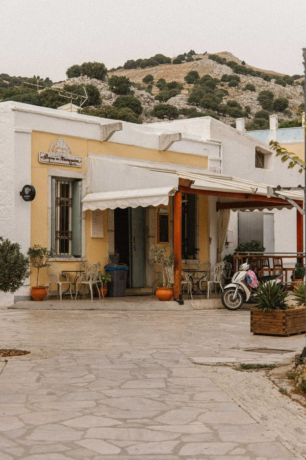Visitors savoring traditional Greek baked goods in a relaxing bakery in Symi.