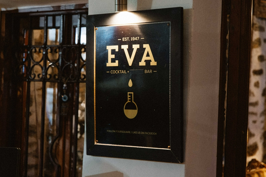 Eva's Cocktail Bar in Gialos, Symi, showcasing vibrant cocktails and a beautiful harbor view.