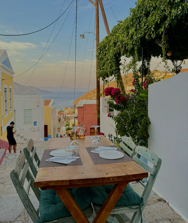 Visitors enjoying a casual stroll along the historic staircase on Symi Island.