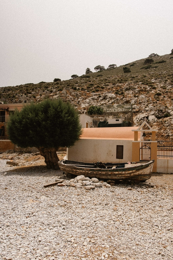 A picturesque view of Marathounda Beach featuring boats, trees, and rocky landscapes.