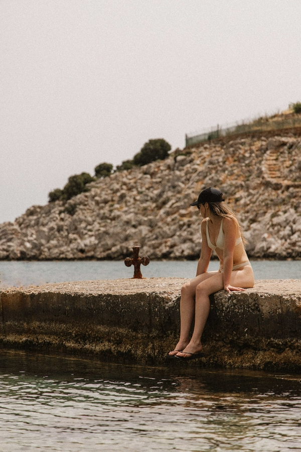 Relaxing scene at Marathounta Beach with clear waters and pebbly shores.