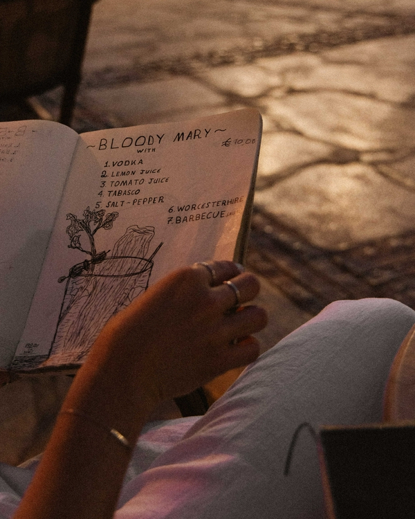 Enjoying creative cocktails at Eva's Cocktail Bar with sea views in Gialos, Symi.