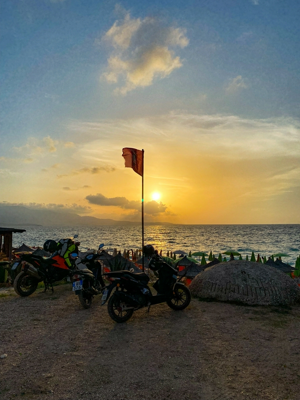 Beautiful sunset view at Ksamil Beach with swimming and beach amenities.