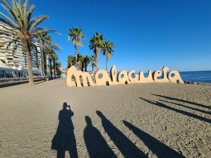 Visitors enjoying a relaxing day at Playa la Malagueta beach.