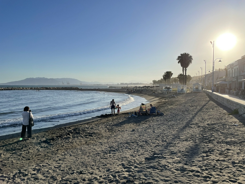 Beach setting in Malaga with a lively chiringuito and festive atmosphere.