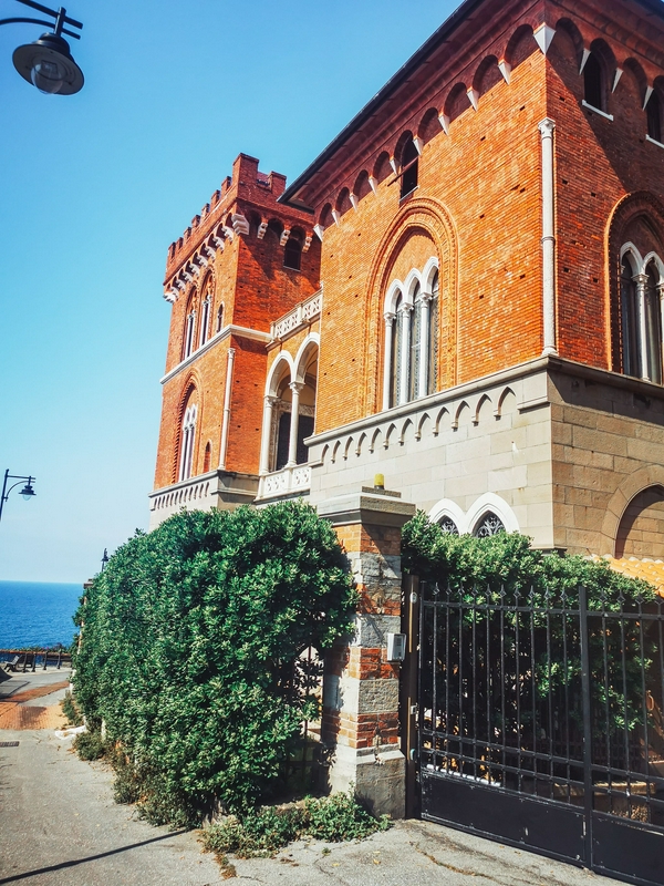 Beautiful Mediterranean architecture featuring bougainvillea and a sea view.